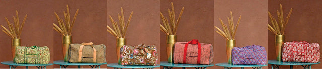 Handcrafted Bundi carry-on bags in colorful prints displayed on a table, Dhonk Craft collection