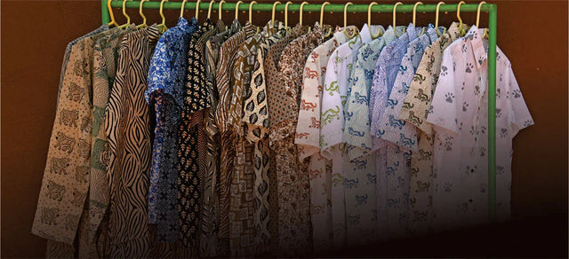Men's handcrafted organic cotton shirts with artisan prints hanging on a rack, Dhonk Craft