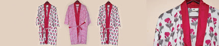 Handcrafted cotton robes and kaftans with pink and red prints, displayed on hangers, Dhonk Craft.
