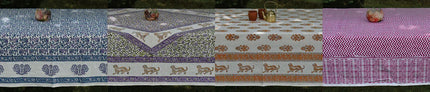 Handcrafted organic cotton tablecloths by Dhonk Craft, featuring vibrant block prints and nature-inspired patterns, displayed outdoors.