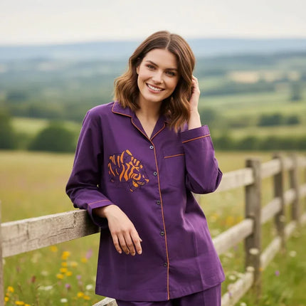 Woman wearing purple organic cotton shirt with tiger motif by Dhonk Craft, outdoors by a fence