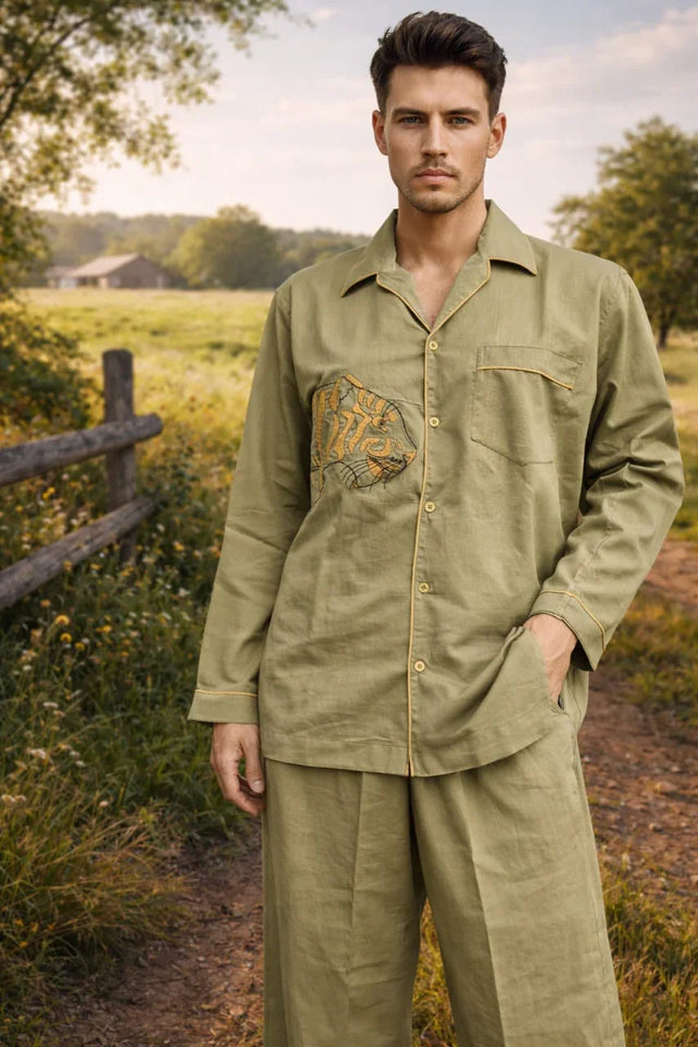 Man wearing handcrafted olive green organic cotton shirt and pants by Dhonk Craft outdoors