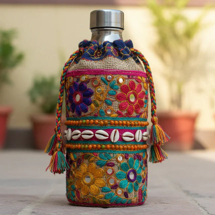 Colorful handcrafted bottle cover with floral embroidery, beads, and shells, Dhonk Craft product.