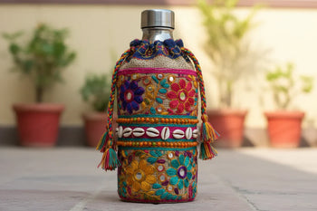 Colorful handcrafted bottle cover with floral embroidery, beads, and shells, Dhonk Craft product.