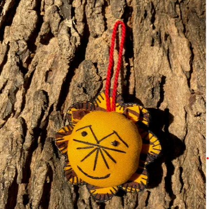 Handcrafted lion ornament by Ranthambore artisans on tree bark, ethical Dhonk Craft decor