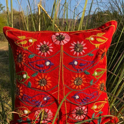 Handcrafted red embroidered cushion with colorful birds and floral designs by Dhonk Craft