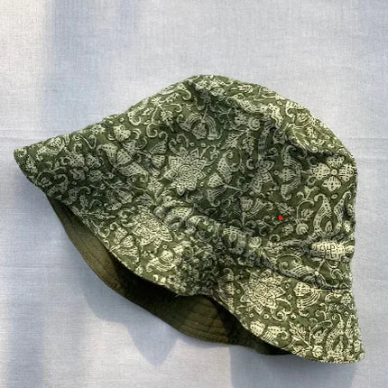 Handcrafted green organic cotton bucket hat with white floral pattern by Dhonk Craft