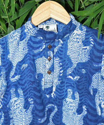 Handcrafted blue and white cotton kurta with tiger print by Dhonk Craft, hanging on a wooden hanger