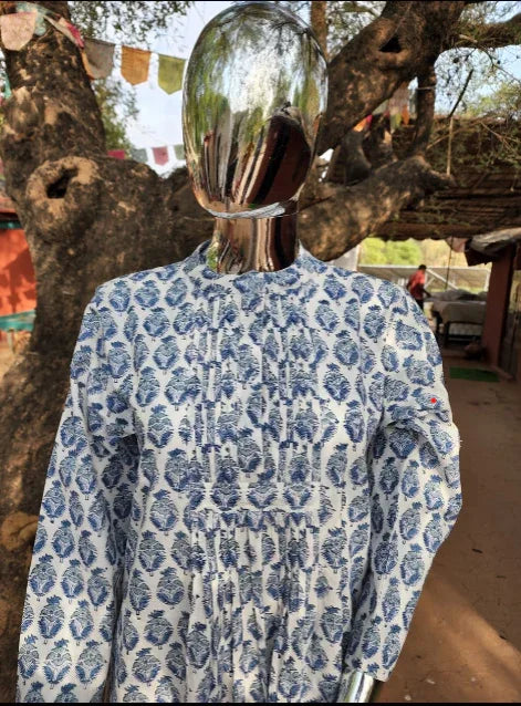 Handcrafted blue and white organic cotton kurta by Dhonk Craft, outdoor artisan setting