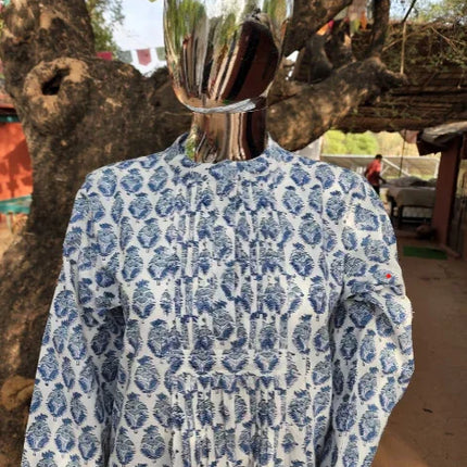 Handcrafted blue and white organic cotton kurta by Dhonk Craft, displayed outdoors by a tree