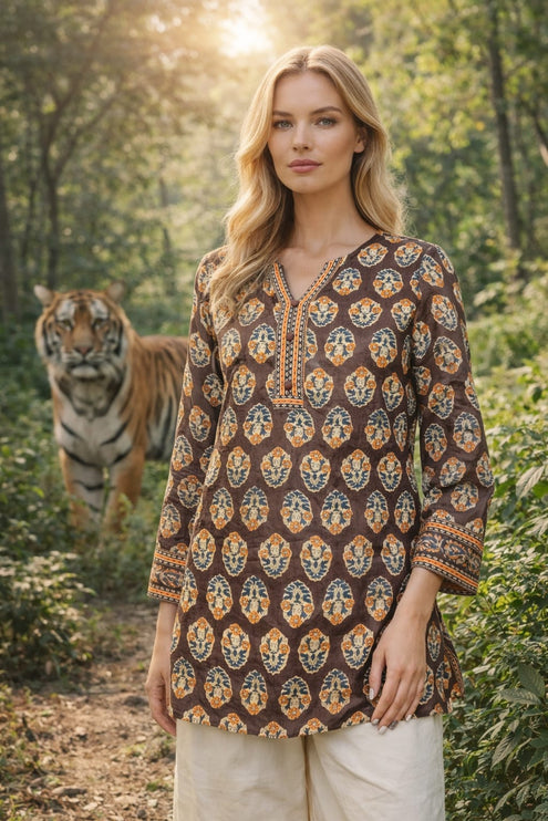 Model posing in Dhonk Craft Deepika short printed brown tunic kurta for women in a nature-inspired forest setting.