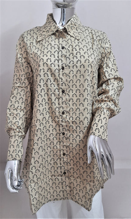 A long sleeve, beige cotton safari shirt with hand block printed patterns, displayed on a mannequin.