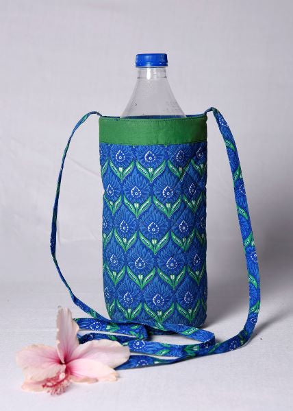 A water bottle covered with a blue and green floral patterned quilted bottle cover, with a detachable sling bag.
