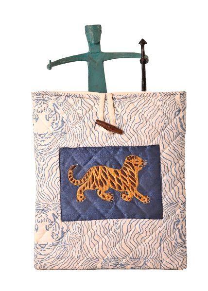 A fabric tablet/iPad cover with a quilted design and an embroidered pattern depicting a tiger. The cover is displayed on a mannequin.