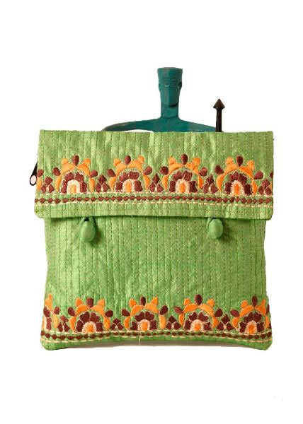 A green fabric purse with multicolor floral embroidery and tassel detailing.