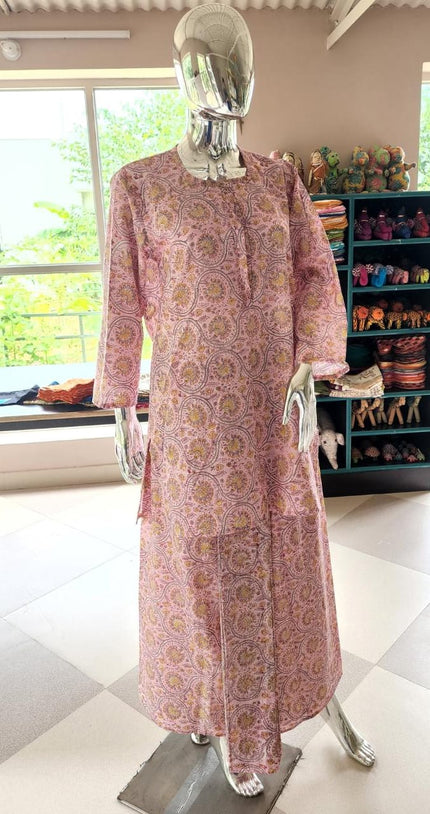 A mannequin wearing a pink floral hand-block printed cotton lungi pajama set for women, featuring a long-sleeve tunic and matching wrap-style bottoms.