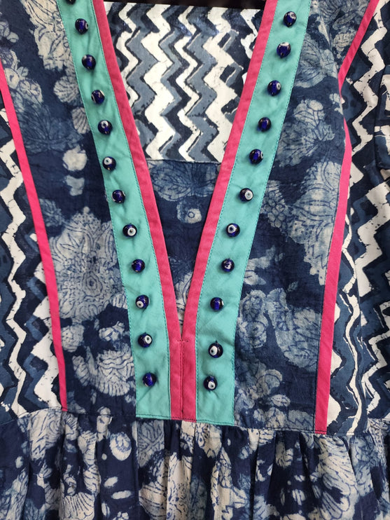 A traditional Moti dress with floral hand block print in blue, green, and pink colors, featuring a zippered belt.