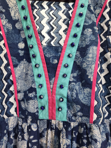 A traditional Moti dress with floral hand block print in blue, green, and pink colors, featuring a zippered belt.