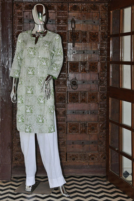 Handcrafted green block print kurta and white pants on mannequin, Dhonk Craft, artisan decor backdrop